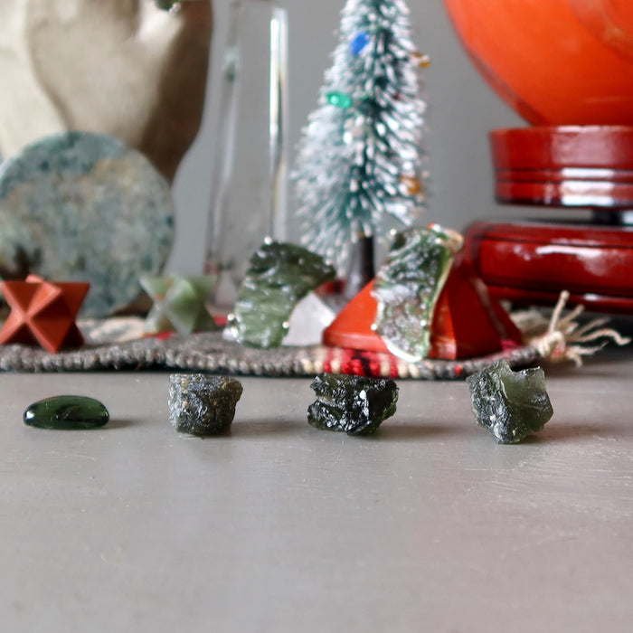 raw moldavite stones in holiday setting