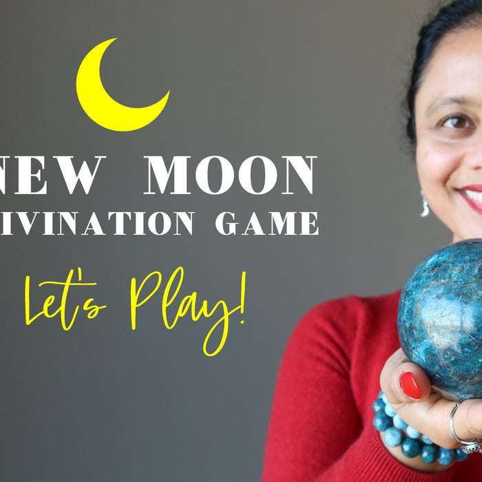 female holding apatite sphere with a sign to play new moon divination game