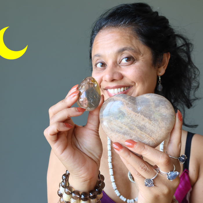 sheila of satin crystals holding smoky quartz egg and moonstone heart
