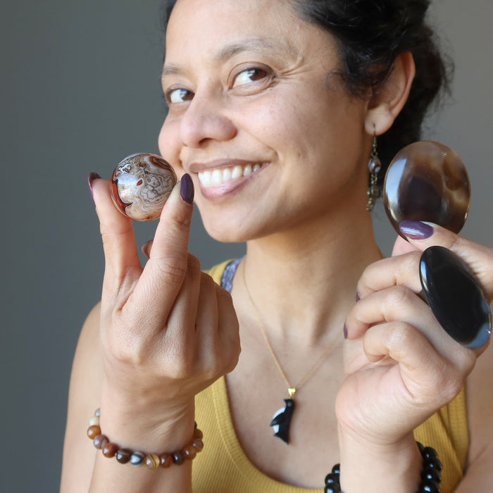 sheila of satin crystals holding sardonyx crystals and wearing onyx jewelry
