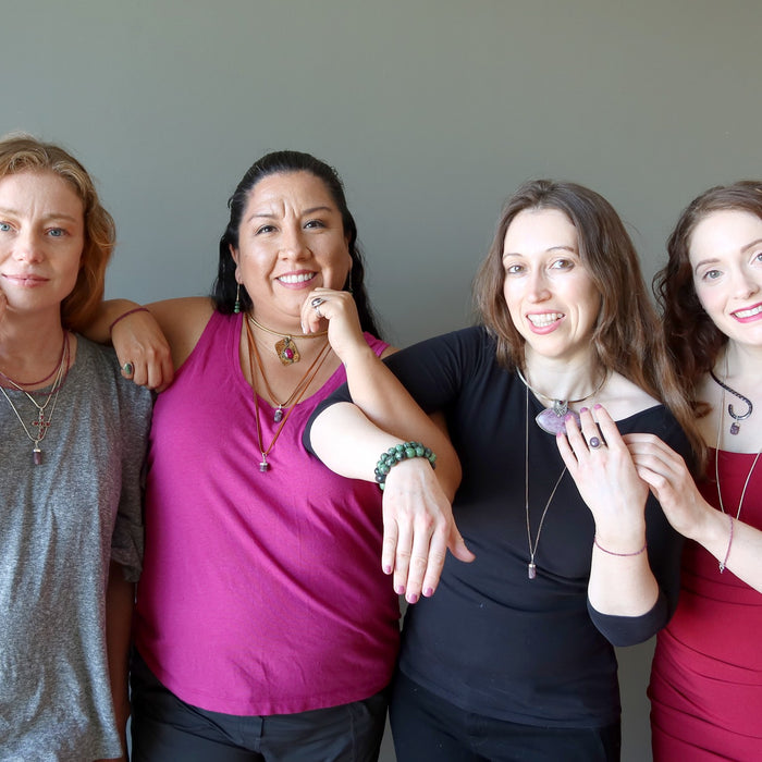 four women wearing ruby jewelry