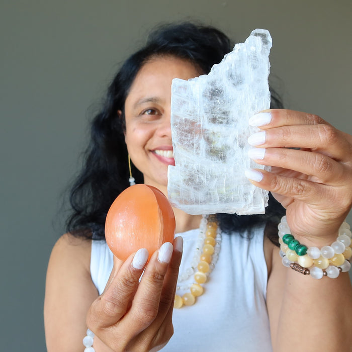 sheila of satin crystals holding true selenite and orange selenite egg