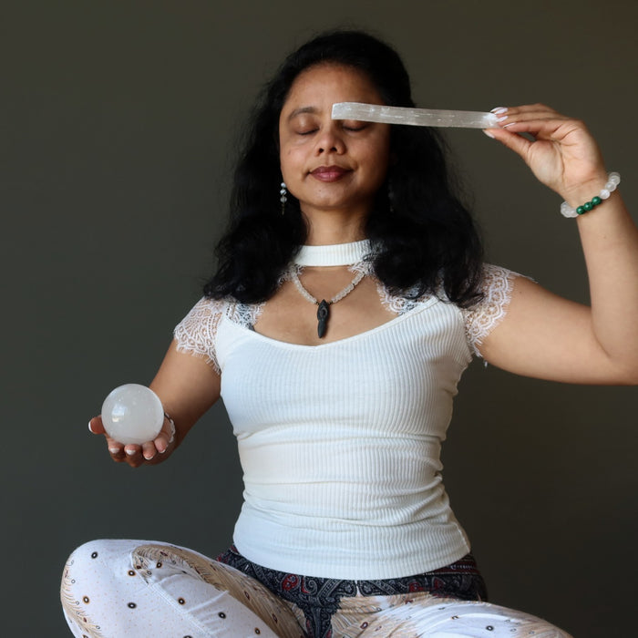 sheila of satin crystals meditating with selenite wand and sphere