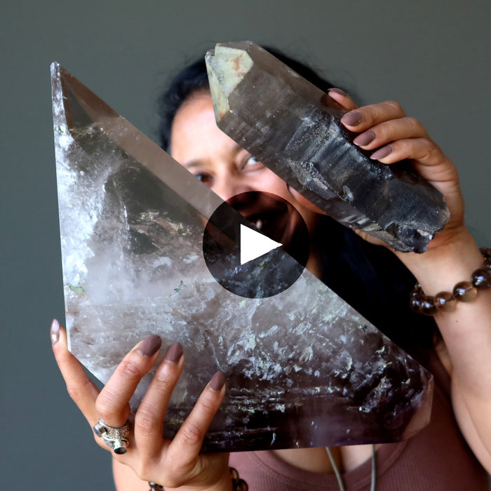 sheila of satin crystals holding two pieces of smoky quartz 