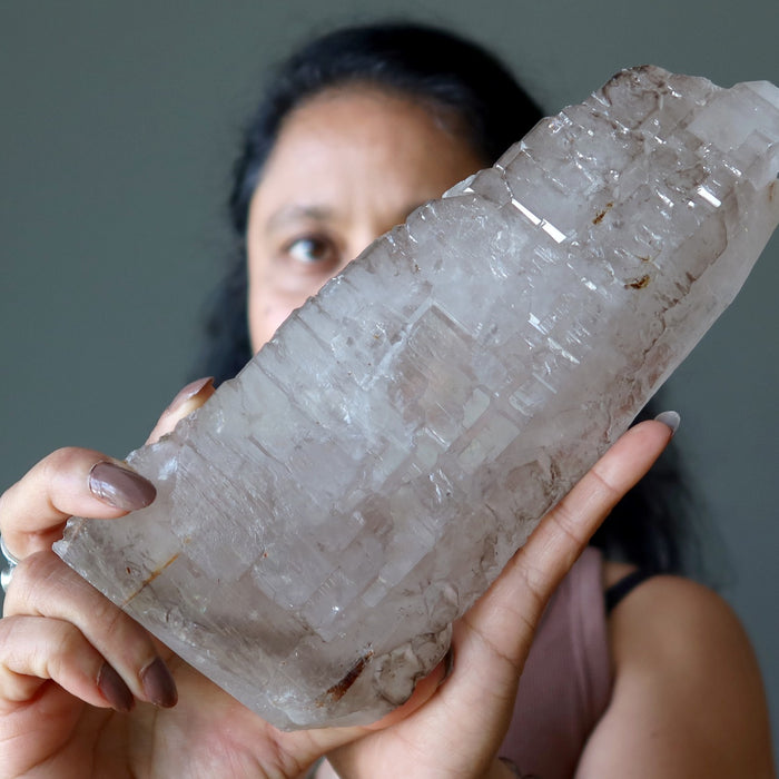 sheila of satin crystals holding a smoky quartz stone