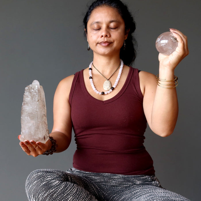 woman meditating with smoky quartz crystals
