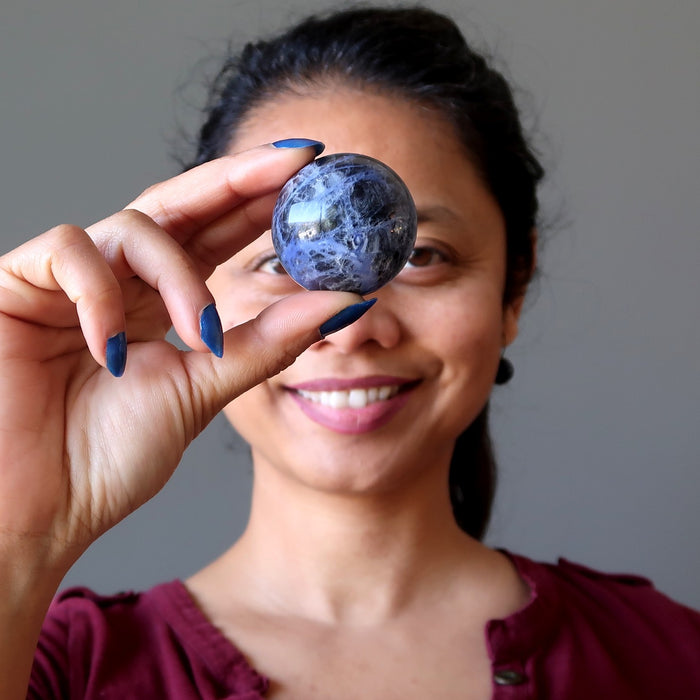 woman with sodalite sphere at third eye chakra