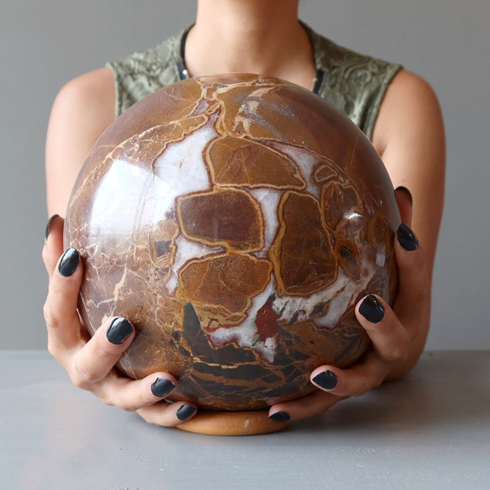 woman's hands holding xl jasper sphere