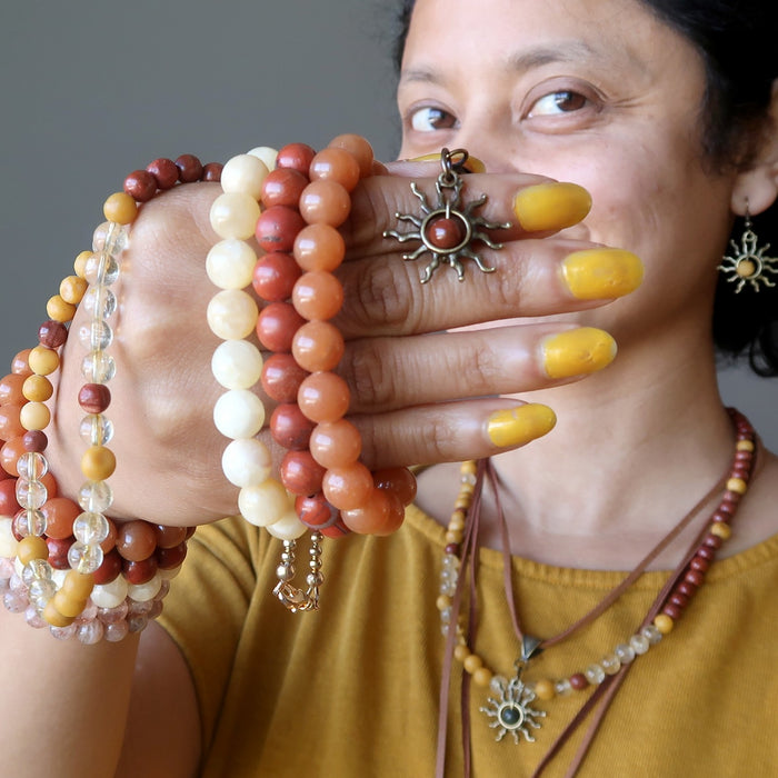 Sheila of Satin Crystals with a handful of bright sun inspired jewelry