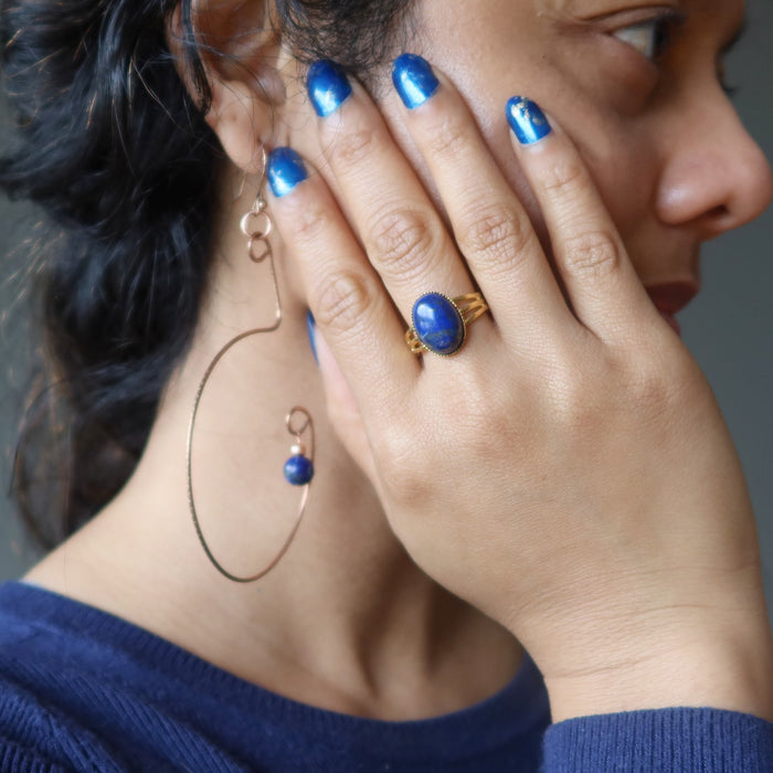 woman wearing lapis ring and earrings