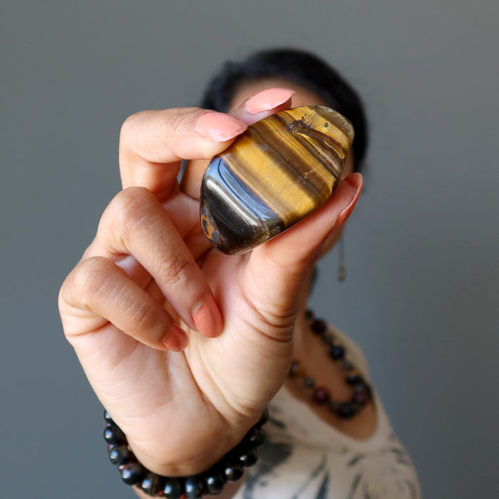 sheila of satin crystals holding a golden tigers eye tumbled stone 