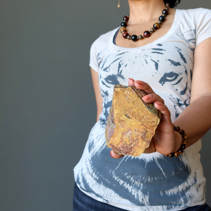 sheila of satin crystals holding a tigers eye stone in front of her tiger tshirt