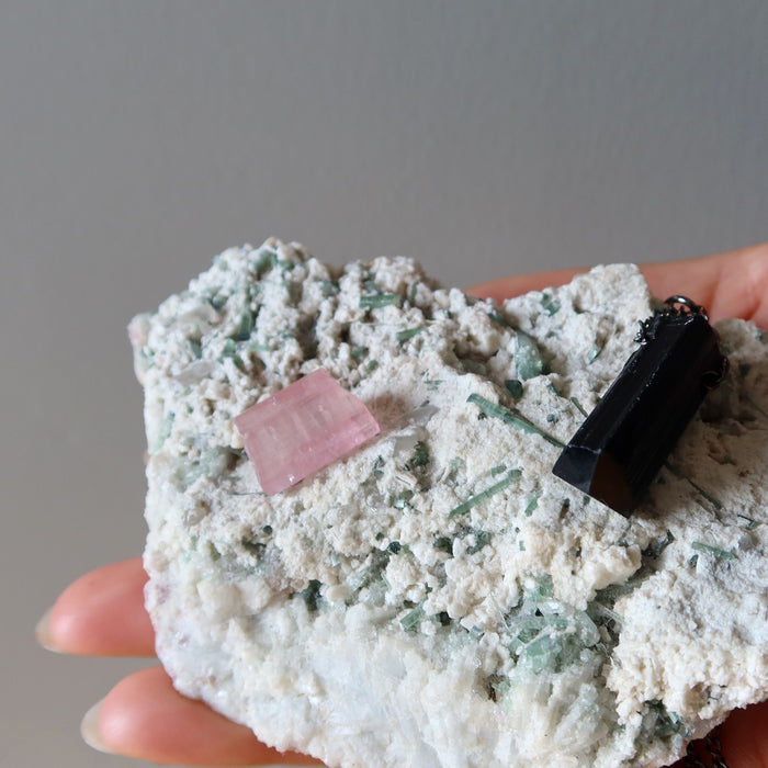 green tourmaline cluster with pink and black tourmaline stones