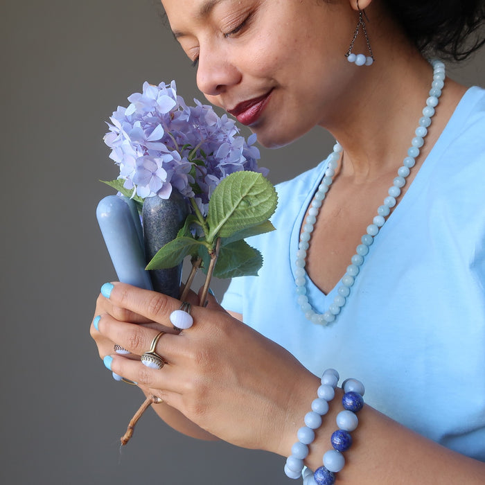 sheila of satin crystals holding a bouquet of flowers and angelite massage wands