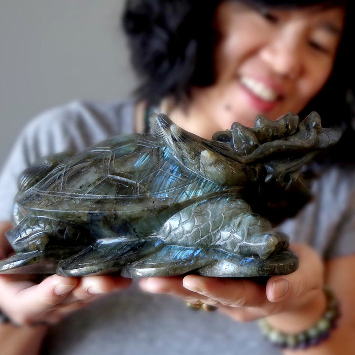 woman holding labradorite dragon turtle