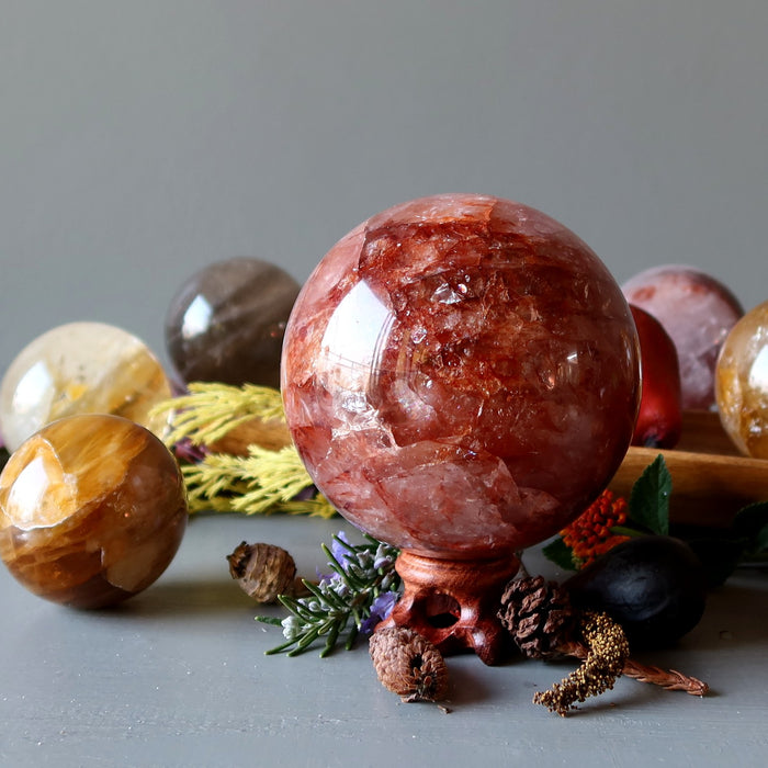 display of colorful quartz crystal balls and fall foliage