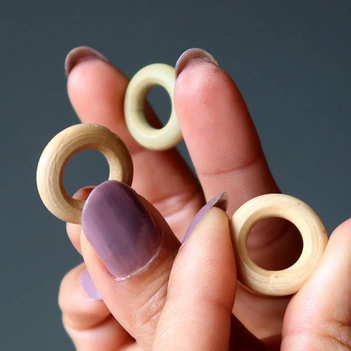 wood ring stands in hand