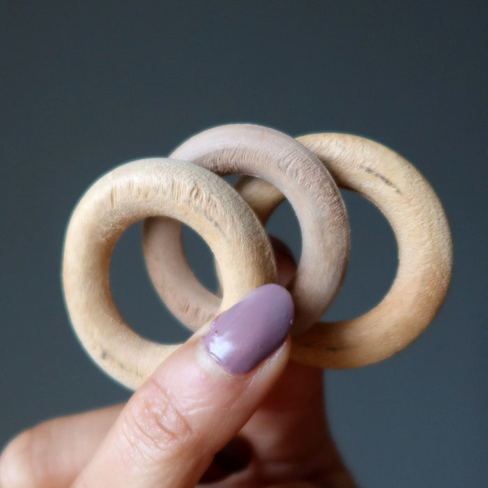 wood ring stands in hand