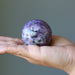 charoite crystal ball in palm
