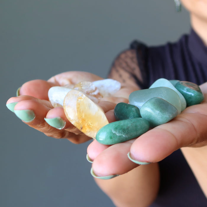 citrine and green aventurine tumbled stone set in hands