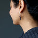 woman wearing hematite earrings