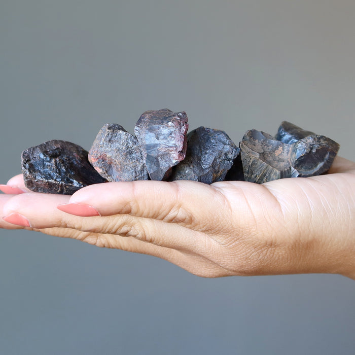 raw hematite clusters in hand