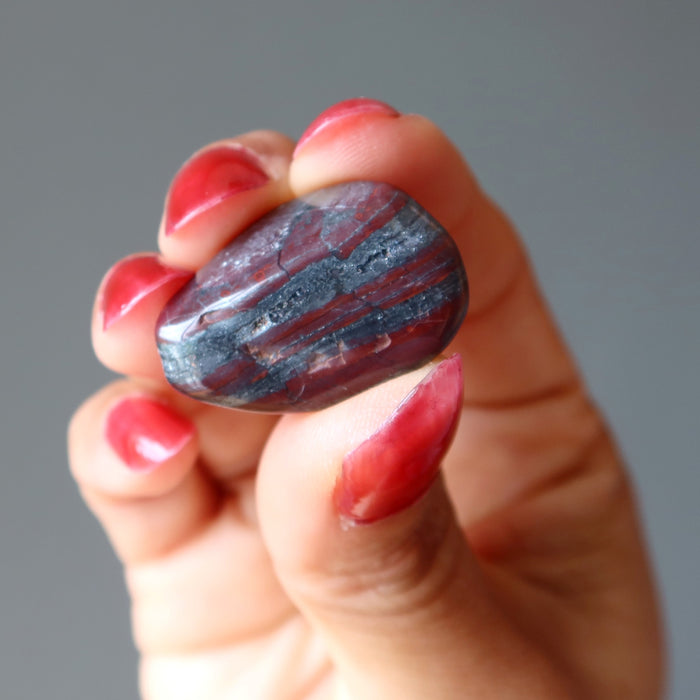 hematite red jasper tumbled stone in hand