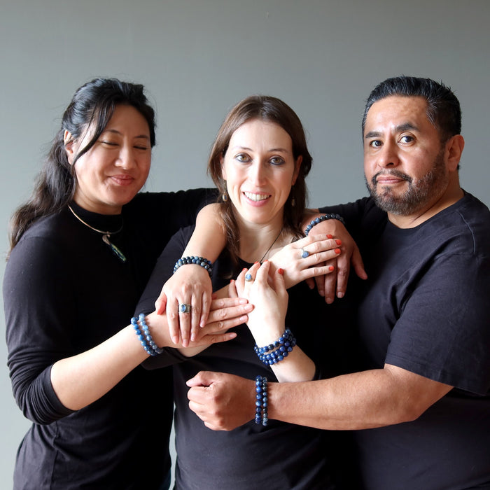 three people wearing kyanite jewelry