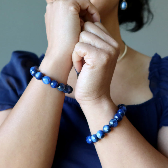 woman wearing kyanite bracelets on hands
