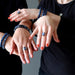 hands wearing kyanite rings and bracelets