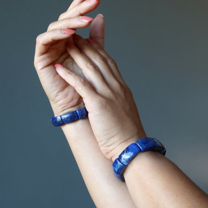 hands wearing lapis lazuli stretch bracelet
