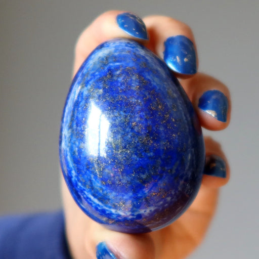 hand holding lapis lazuli egg