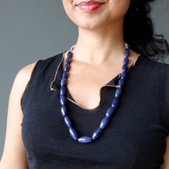 woman wearing lapis beaded necklace