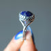hand holding lapis lazuli sterling silver ring