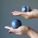 two denim lapis sphere in palms of hand