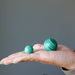 bullseye malachite spheres in hand