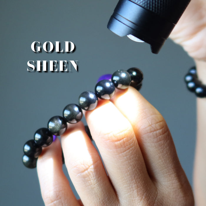 gold sheen obsidian bracelet under light