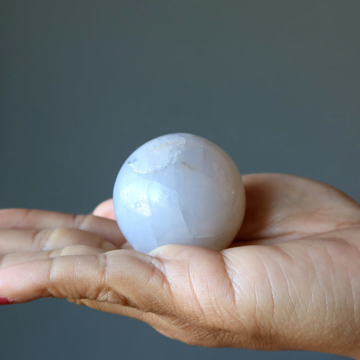 blue quartz sphere in hand