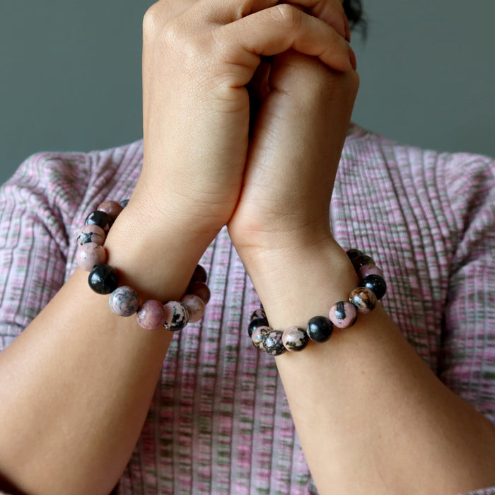 woman wearing rhodonite bracelets