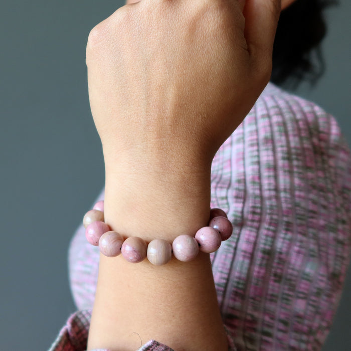 woman wearing rhodonite bracelet