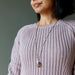 rhodonite necklace over sweater