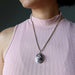 woman wearing rhodonite oval pendant necklace