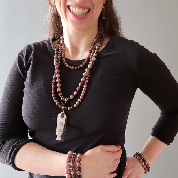 woman wearing rhodonite jewelry