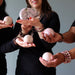 group holding pink rhodonite spheres and bear