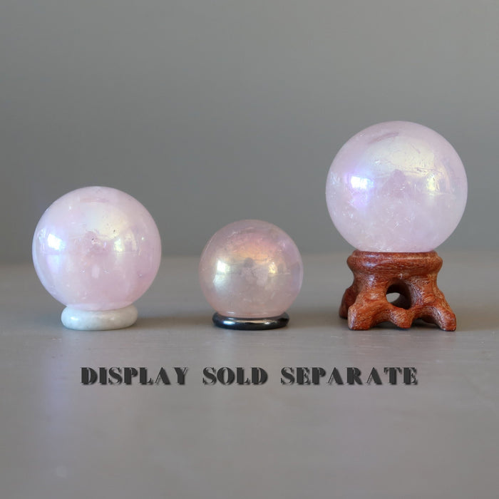 three aura rose quartz crystal balls on stands