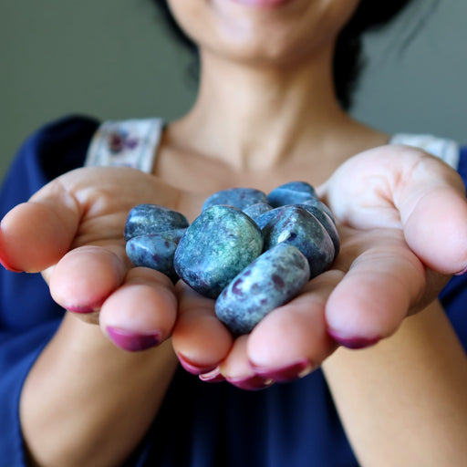 ruby kyanite tumbled stones in hands