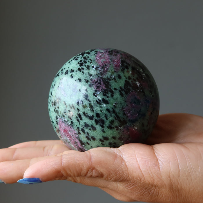 ruby zoisite sphere in hand