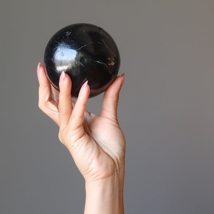 black tourmaline sphere in hand