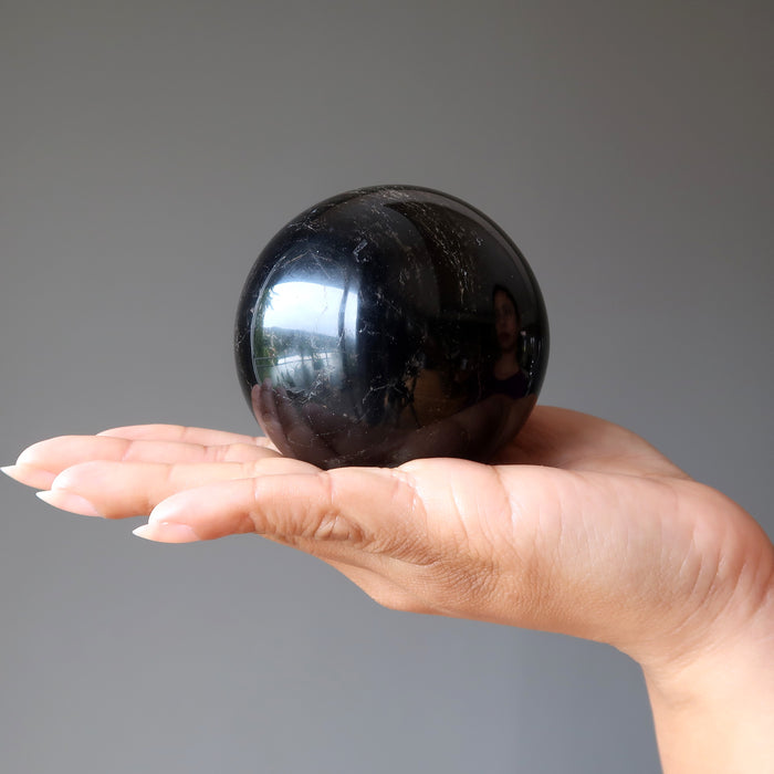 black tourmaline sphere in hand