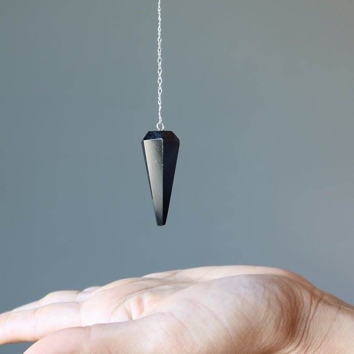 dowsing with black tourmaline faceted pendulum